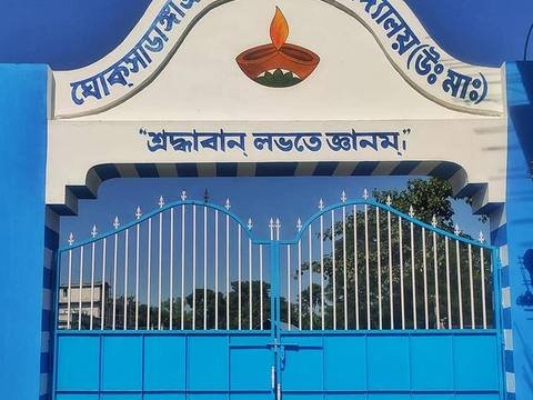 The blue and white school gate with the school name and motto painted on the arch
